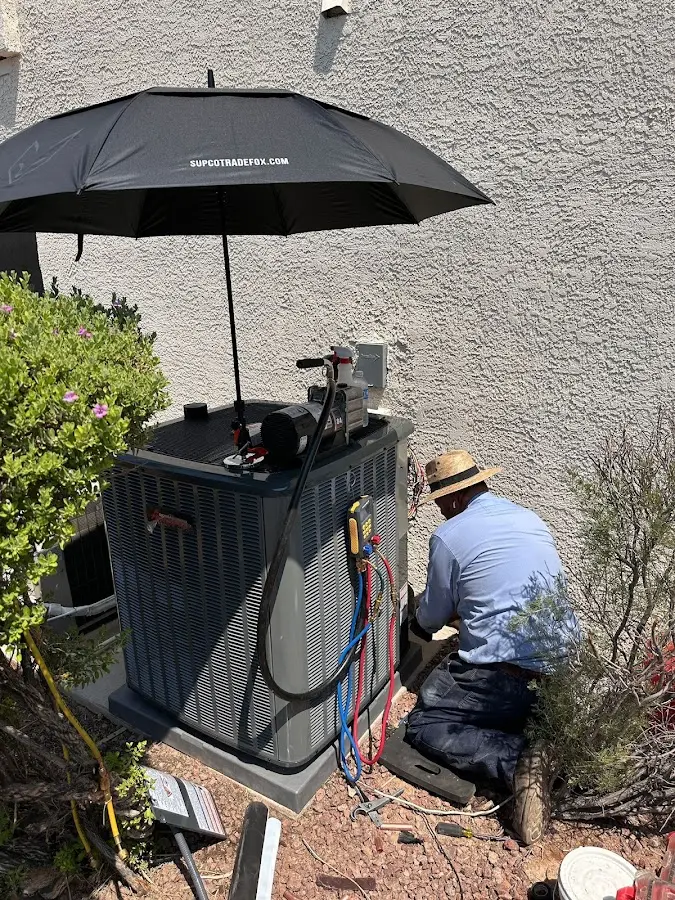 HVAC technician performing outdoor AC maintenance in Grand Island